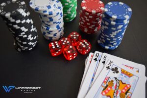 casino chips with dice and playing cards being used in casino games